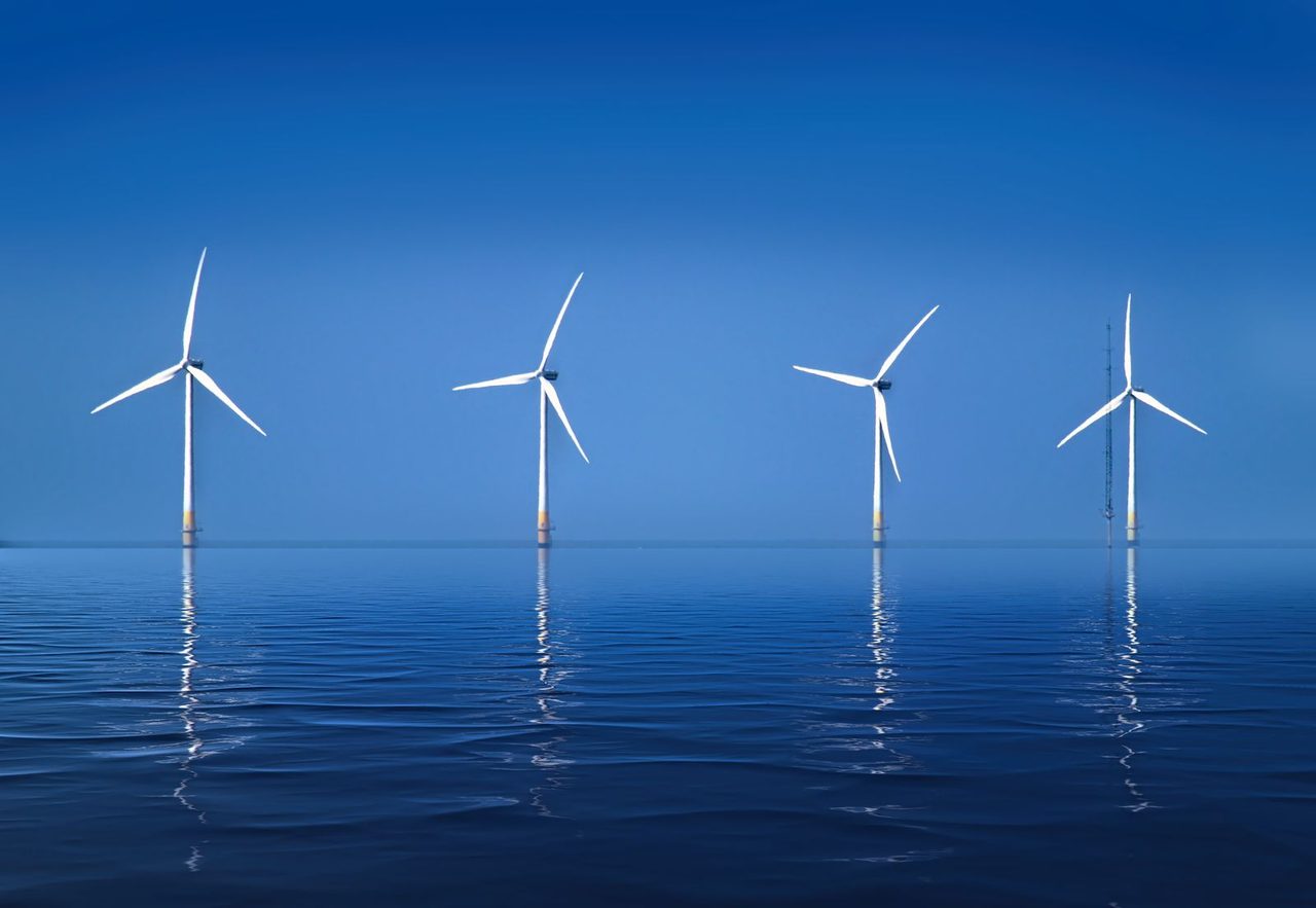 Wind turbines at sea - renewables overtake coal as the world's largest electricity source in 2026, per the IEA.